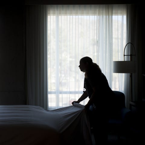 Sally Gerena prepares a bed in a room at Mountain 