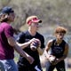 Oklahoma quarterback Spencer Rattler, center,  works out with Hamilton quarterback Nicco Marchiol (left) and Kaden Millner, a middle school student, under the guidance of Mike Giovando at Mountain View Park in ScottsdaleKaden Millner, Ariz. on March 20, 2020.