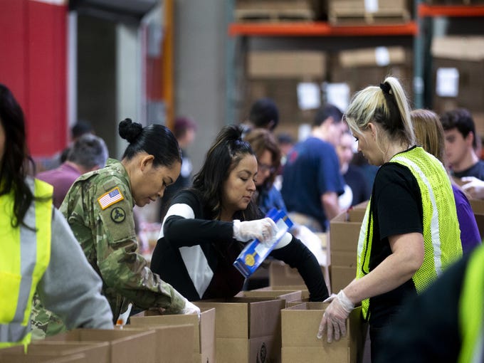Volunteers package food at St. Mary's Food Bank in Phoenix, Ariz. on March 20, 2020.