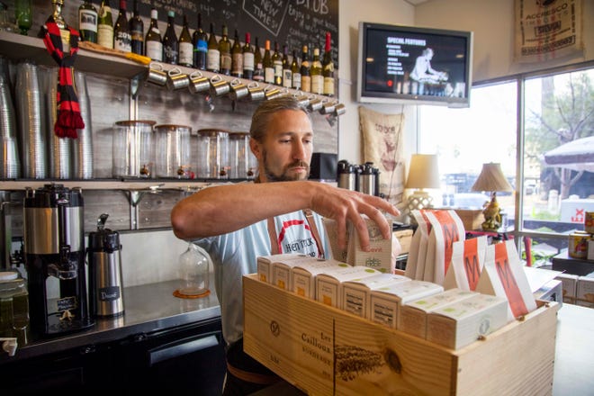 Craig Dziadowicz, owner of the Hidden Track Bottle Shop, turned his wine store into a mini grocery store while many retail locations are closed due to the coronavirus. Local residents can shop for produce and other food items as well as the usual wine offerings.