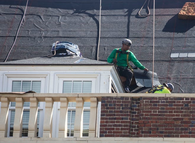 Workers install a new roof on Lee Hall at FAMU, Friday, March 20, 2020. 