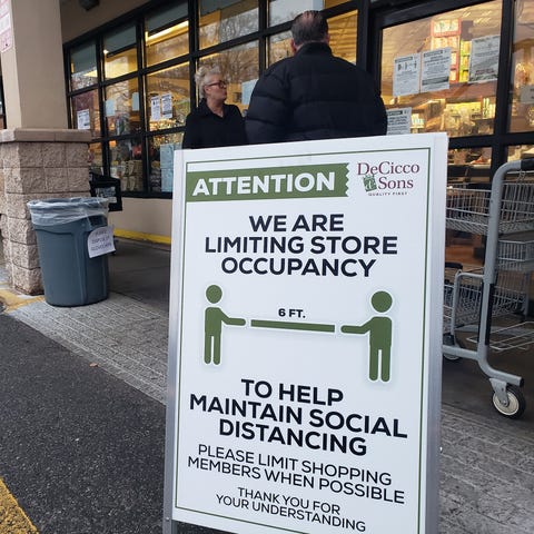 Shoppers line up at a grocery store in Ardsley, NY