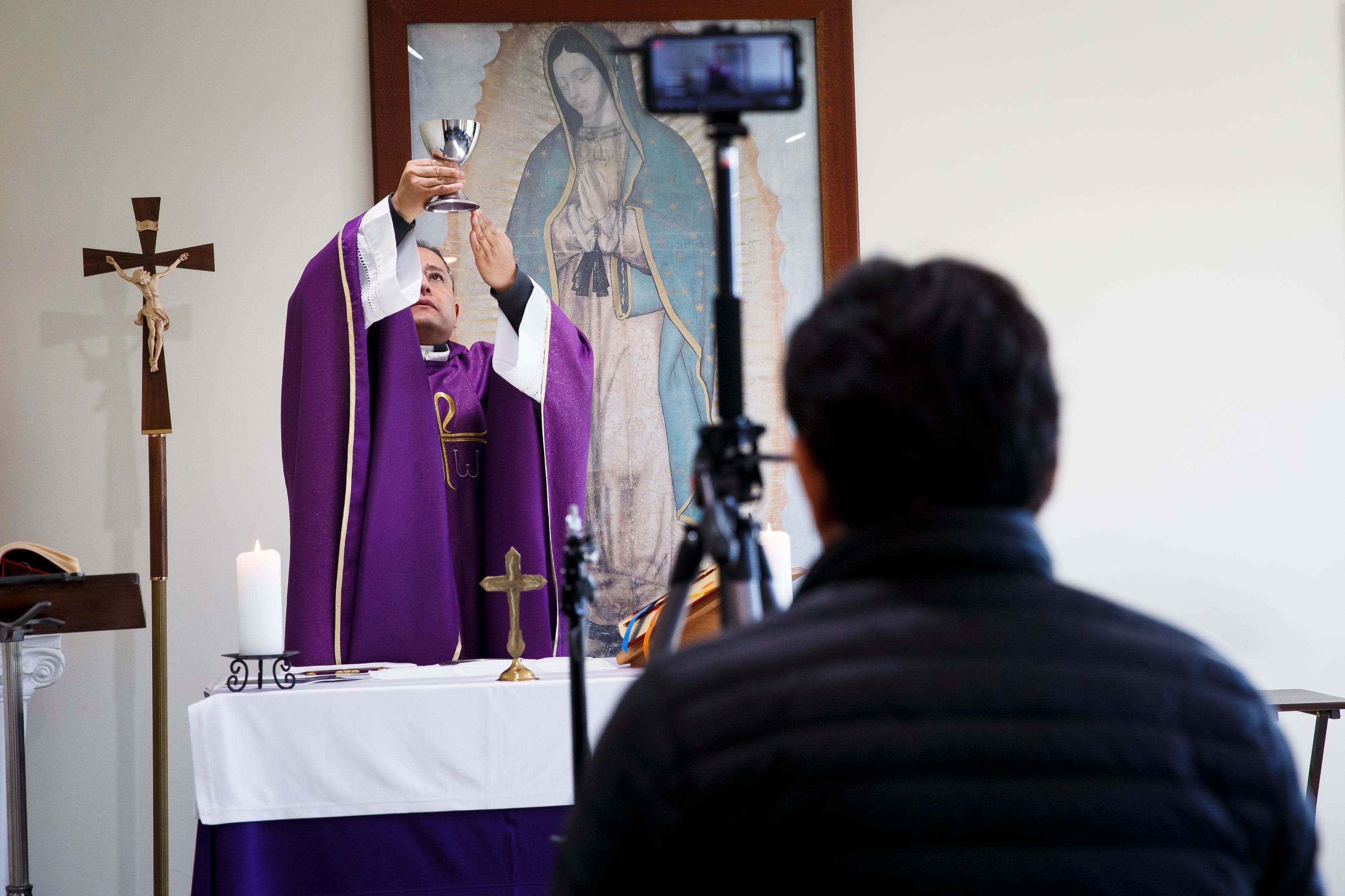 The Rev. Fabian Moncada celebrates Mass in a makeshift chapel as it's streamed live to followers of Our Lady of the Americas Church on Saturday, March 21, 2020, in Des Moines.