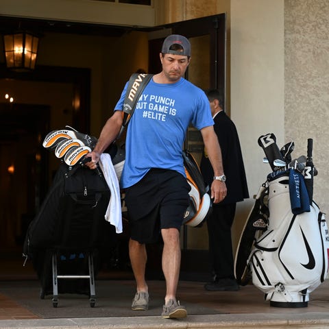 Kevin Kisner leaves the clubhouse after the cancel