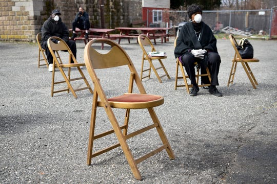 First Bethel AME Church in Paterson conducts a worship service in the church's parking lot, keeping chairs six feet apart in accordance with social distancing practice recommendations from the CDC on March 22, 2020.
