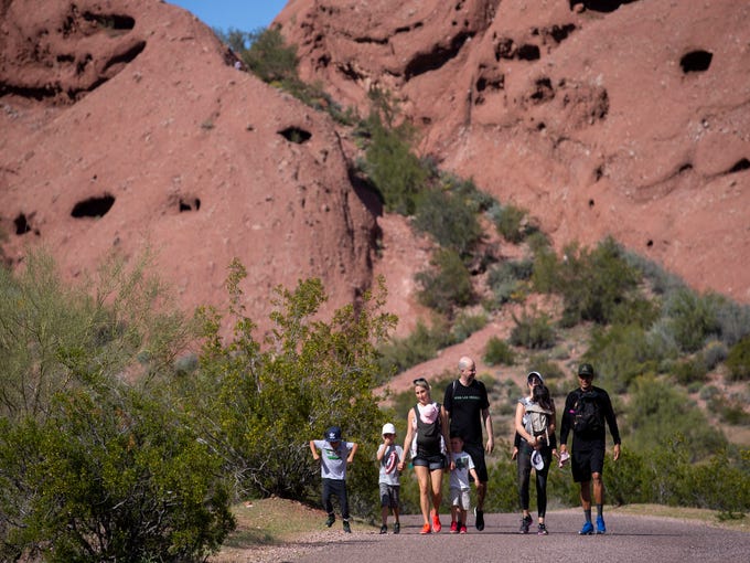 People hike at Papago Park on March 14, 2020, in Phoenix.