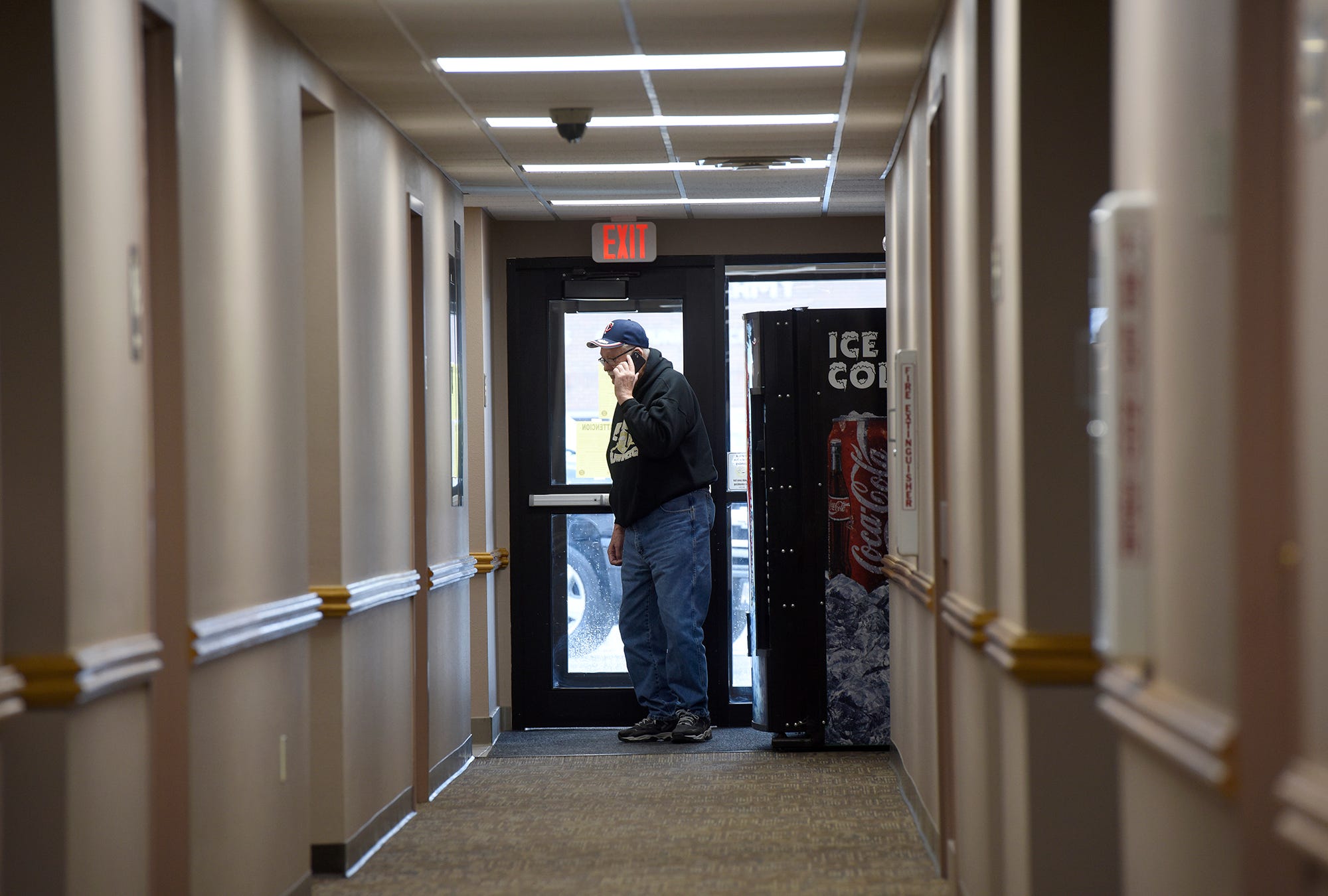 Huron mayor Paul Aylward talks on the phone during a break from executive session. "We're going to take a lot of crap for this, but it's what we've got to do." Later, the City Council announced they were mandating that all non-essential businesses close.