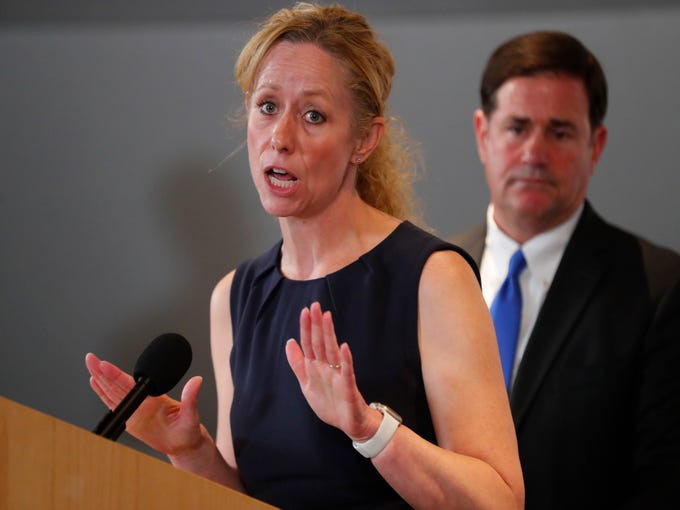 DHS Director Dr. Cara Christ along with Gov. Doug Ducey gives an update on COVID-19 during a news conference at the Arizona State Public Health Laboratory in Phoenix March 23, 2020.