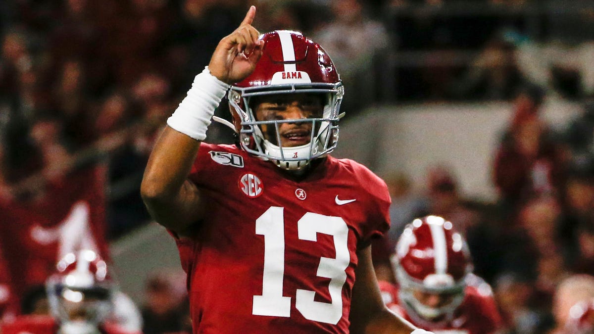 Alabama Crimson Tide quarterback Tua Tagovailoa (13) celebrates after a touchdown during the first half of an NCAA football game against the Tennessee Volunteers at Bryant-Denny Stadium.