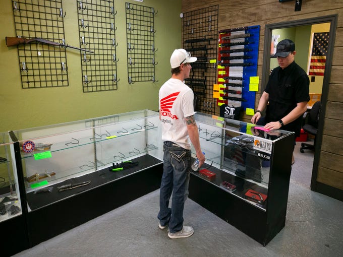 Shawn Ray, owner of S2 Armament LLC, tells a customer that nearly all inventory of firearms and ammo are sold out at Patriot Nation Firearms and Accessories in Phoenix.