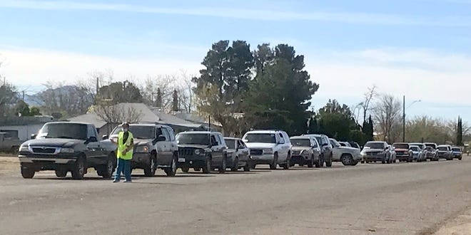 South Diamond Street was lined with vehicles early Wednesday morning waiting the food distribution center at Santa Ana Catholic Church to begin handing out food boxes for families in need. The lined of vehicles backed up traffic south to Cody Road.