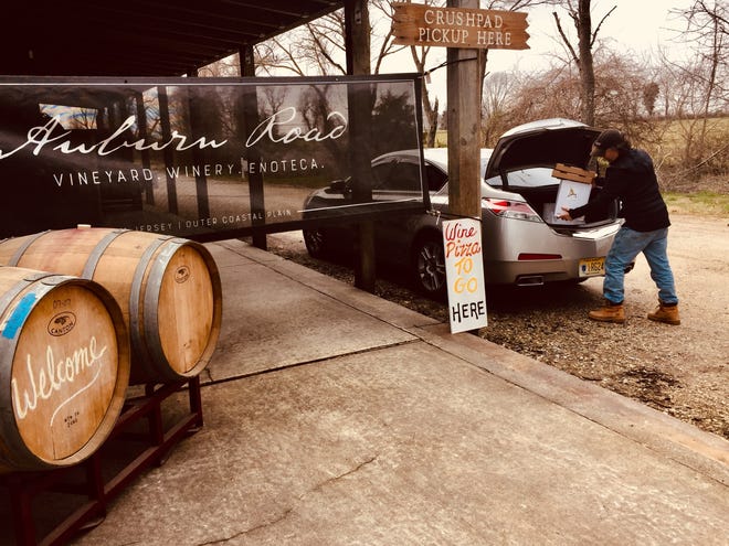Scott Donnini of Auburn Road Vineyard fills a customer's trunk with their wine order. Wineries across New Jersey are offering curbside pickup and delivery during the coronavirus pandemic.