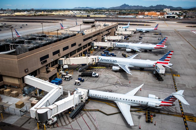 American Airlines planes fill Terminal 4 at Phoenix Sky Harbor International Airport on March 26, 2020.