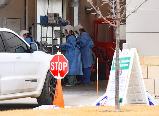 People drive into a garage to be tested for COVID-19 on Thursday, March 26, at the Avera Medical Group Family Health Center in Sioux Falls.