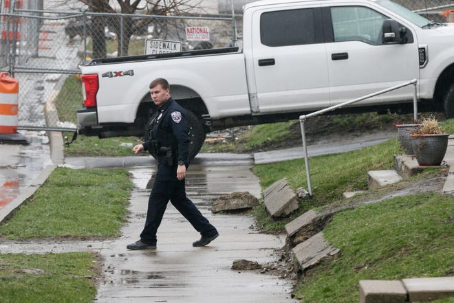 A Lafayette Police officer walks back to his cruiser after responding to a call, Thursday, March 26, 2020 in West Lafayette.