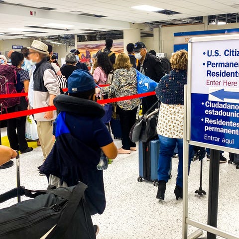 U.S. citizens line up to board a U.S. Immigration 