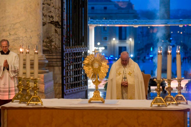 Pope Francis prepares to give the Urbi et orbi blessing after presiding over a moment of prayer on the sagrato of St Peter's Basilica, the platform at the top of the steps immediately in front of the facade of the church.