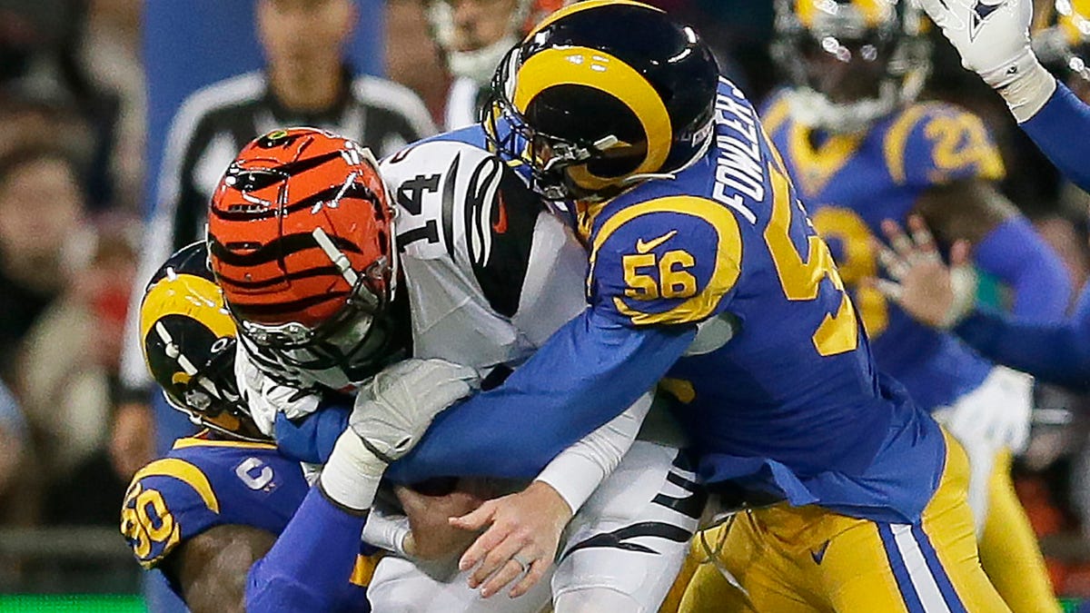 FILE - In this Oct. 27, 2019, file photo, Cincinnati Bengals quarterback Andy Dalton (14) is sacked by Los Angeles Rams defensive end Michael Brockers (90) and defensive end Dante Fowler (56) during the first half of an NFL football game at Wembley Stadium in London. A person familiar with the deal says the Atlanta Falcons have agreed to sign outside linebacker Dante Fowler. The person spoke to The Associated Press on condition of anonymity because free-agent signings   can't be announced until after the league year begins Wednesday afternoon, March 18, 2020. (AP Photo/Tim Ireland, File) ORG XMIT: NY181