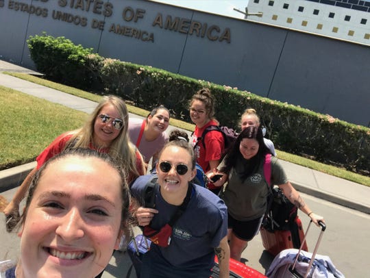 Kirby Given (center in navy) leave the U.S. Embassy in Peru for their flight home