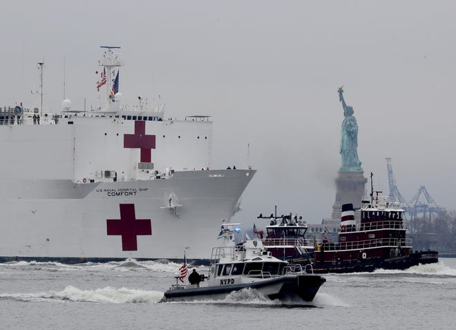 The U.S. Navy Hospital Ship Comfort makes its way past the Statue of Liberty as it sails into New York City March 30, 2020.