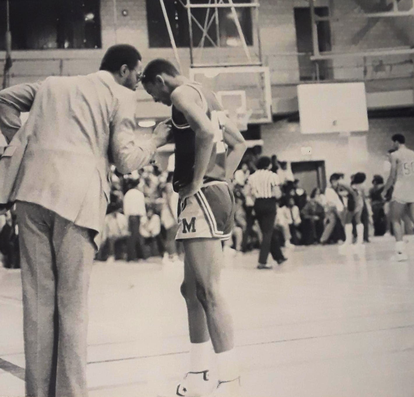 Dwight Jones speaks with player Eric Longmire in this photo from their matchup against Mackenzie in 1981.