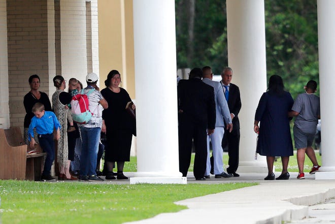 Congregants gather after services at the Life Tabernacle Church in Central, La., on Sunday, March 29. Pastor Tony Spell has defied a shelter-in-place order by Louisiana Gov. John Bel Edwards, due to the new coronavirus pandemic, and continues to hold church services with hundreds of congregants.