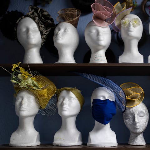 Mannequins with Derby hats sit on a shelf with som