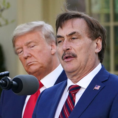 President Donald Trump listens to Michael Lindell,