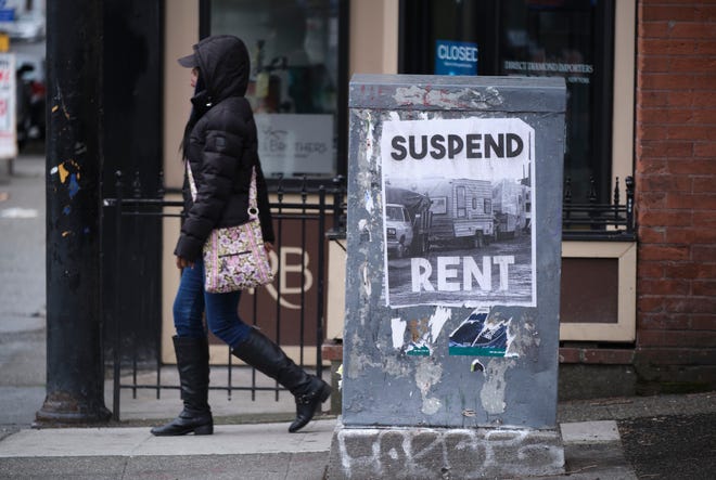 A sign calling for the suspension of rent during the COVID-19 outbreak is pictured in downtown Seattle, Washington, March 26, 2020.