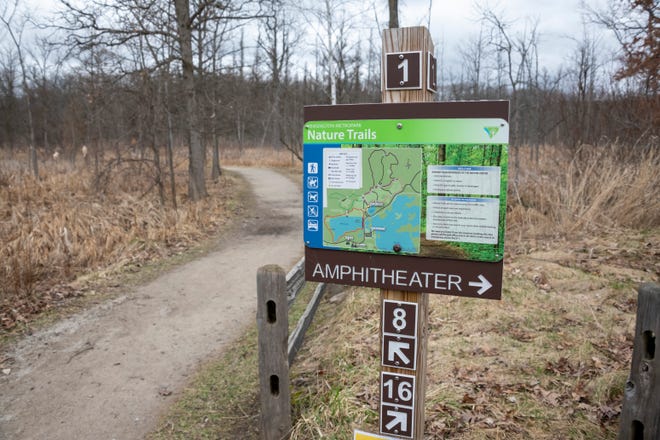 A sign directs people to the nature trails at Kensington Metropark, in Milford, April 1, 2020.