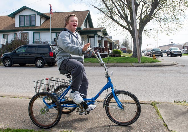 Ryan Green, 15, rides down the sidewalk near his home the day after his trike was stolen and found Wednesday afternoon April 1, 2020. Green has Down’s Syndrome and since school has been out due to the COVID-19 pandemic he has been riding every day. After his mother, Soni Stinson,  wrote about the theft on social media numerous people reached out to help and one anonymous person purchased a new trike for Green which will arrive on April 7th. Green's trike was returned Tuesday evening after being found about 20 blocks from their home.