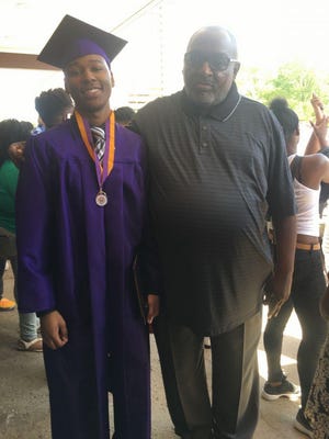 Ralph Davis poses with a Milwaukee Washington High School student at the school's graduation. Davis, 60, who had diabetes, died of COVID-19 on March 25.