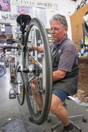 Coowner Tom Pilcher repairs a bike at CycleSports Bicycles on North Palafox Street in Pensacola on Tuesday, March 31, 2020. The shop has seen an increase in business as people are biking more during the coronavirus pandemic.