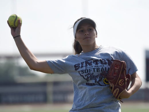 Kiersten Lopez prepares to throw the ball during a practice with her twin sister, Kaylle, Thursday, March 26, 2020, at Sinton High School. Both athletes are committed to University of Houston-Victoria.