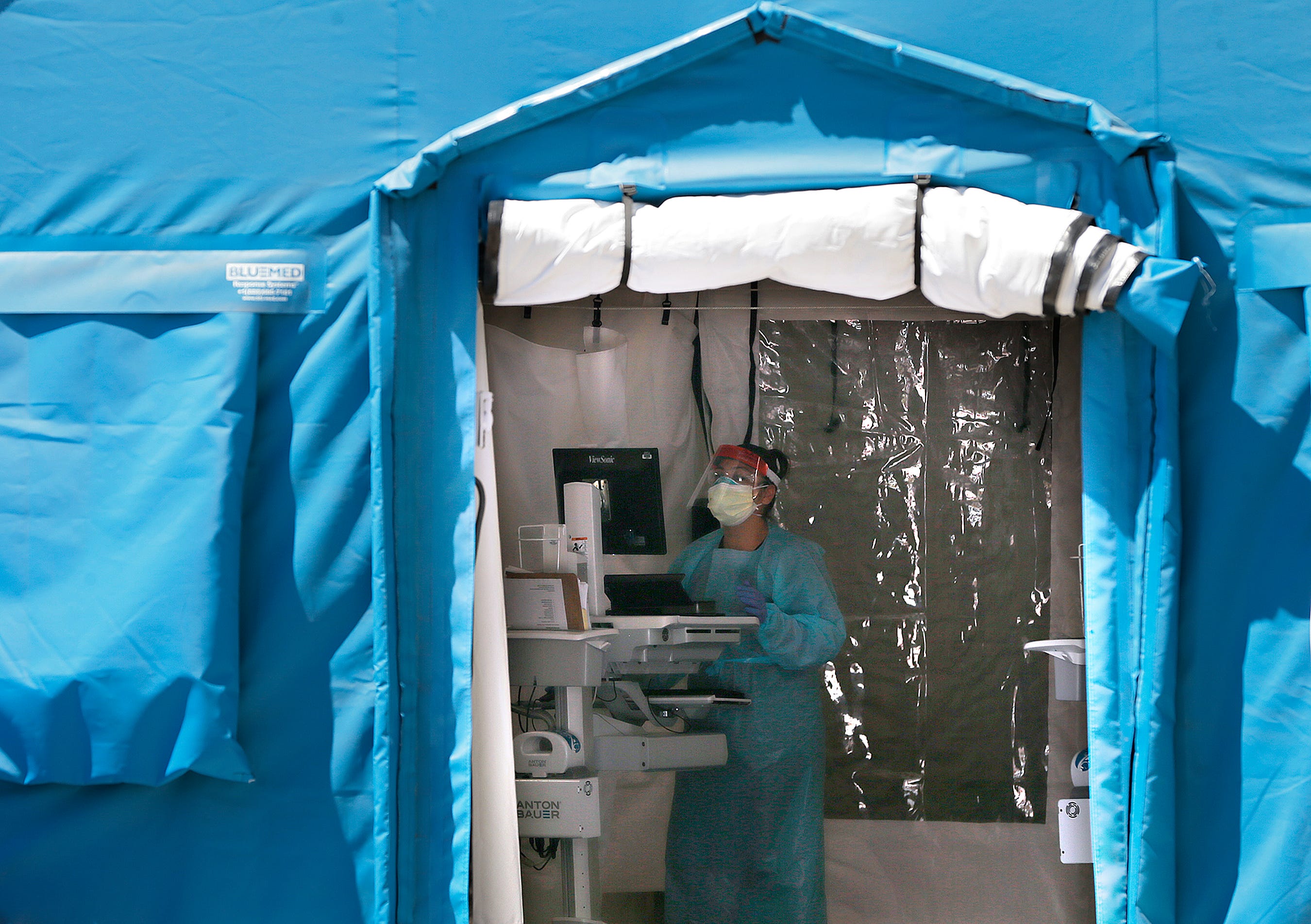 University Medical Center of El Paso registered nurse Claudia Rodriguez works with a coronavirus patient in one of the tents outside the hospital on April 2, 2020. UMC was treating six active cases.