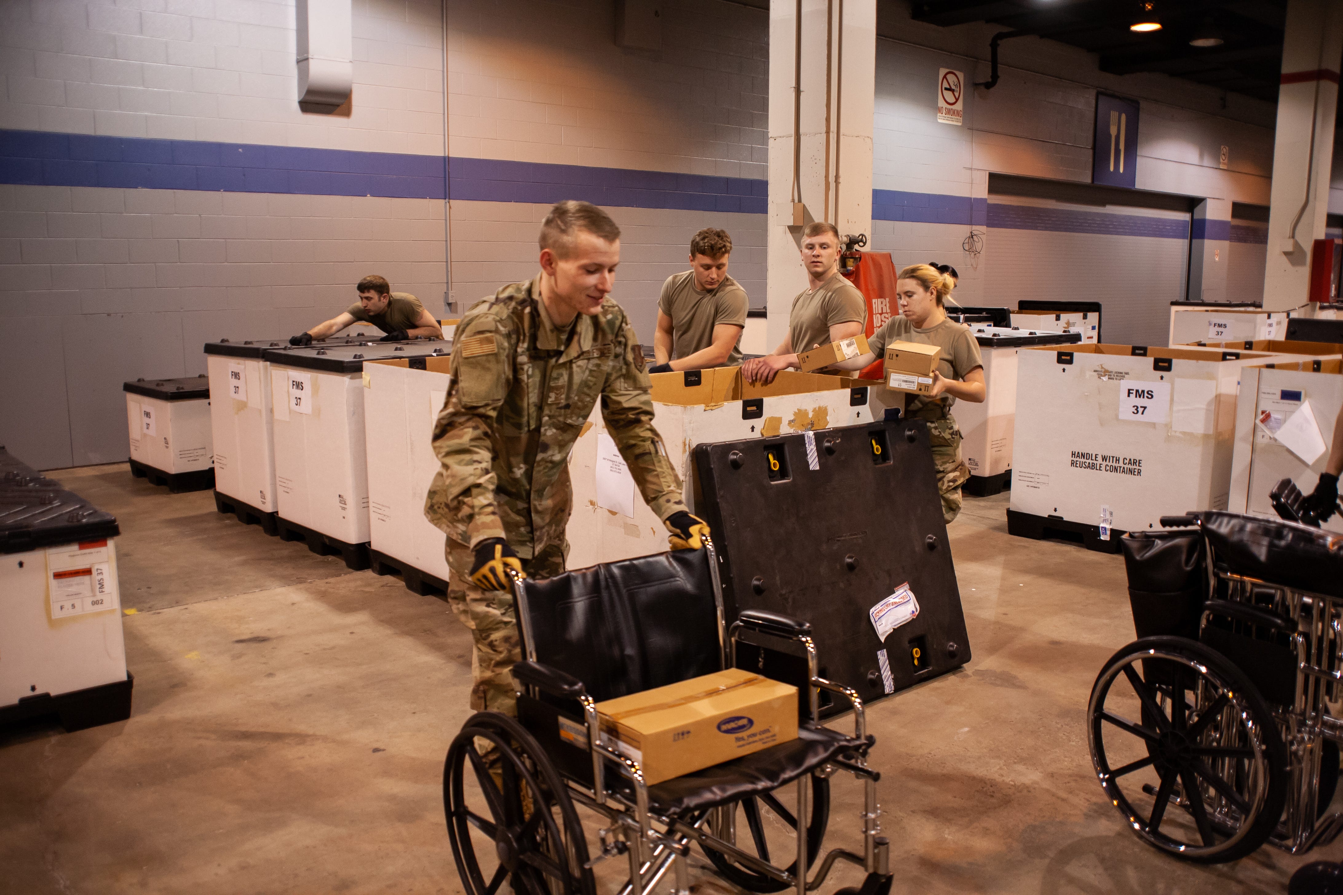 Members of the Illinois Air National Guard assemble medical equipment at the McCormick Place Convention Center in response to the COVID-19 pandemic in Chicago, Ill., March 30, 2020. Approximately 30 members of the Illinois Air National Guard were activated to support the US Army Corps of Engineers and the Federal Emergency Management Agency (FEMA) to temporarily convert part of the McCormick Place Convention Center into an Alternate Care Facility (ACF)   for COVID-19 patients with mild symptoms who do not require intensive care in the Chicago area. (U.S. Air Force Photo by Senior Airman Jay Grabiec)