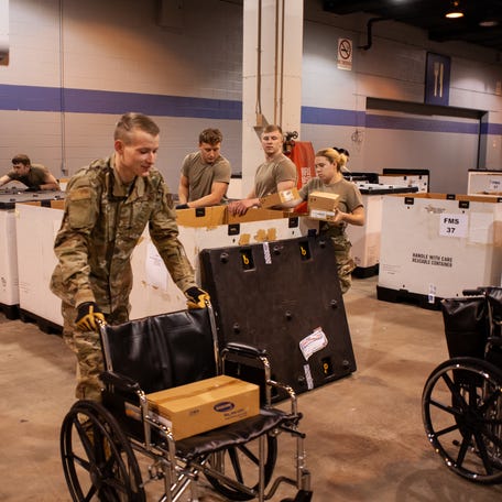 Members of the Illinois Air National Guard assemble medical equipment at the McCormick Place Convention Center in response to the COVID-19 pandemic in Chicago, Ill., March 30, 2020. Approximately 30 members of the Illinois Air National Guard were activated to support the US Army Corps of Engineers and the Federal Emergency Management Agency (FEMA) to temporarily convert part of the McCormick Place Convention Center into an Alternate Care Facility (ACF)   for COVID-19 patients with mild symptoms who do not require intensive care in the Chicago area. (U.S. Air Force Photo by Senior Airman Jay Grabiec)
