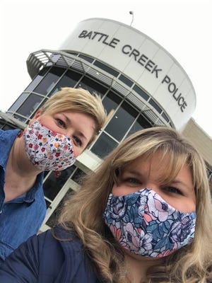 Jennifer Rogers (left) and Jennifer Ellison wear fabric masks outside the Battle Creek Police Department.
