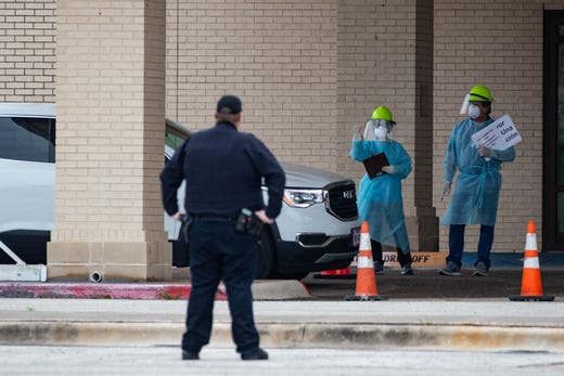 Heath care workers conduct COVID-19 testing at the Corpus Christi's drive-thru testing center at the old Christus Spohn Memorial Hospital parking lot on Friday, April 3, 2020.