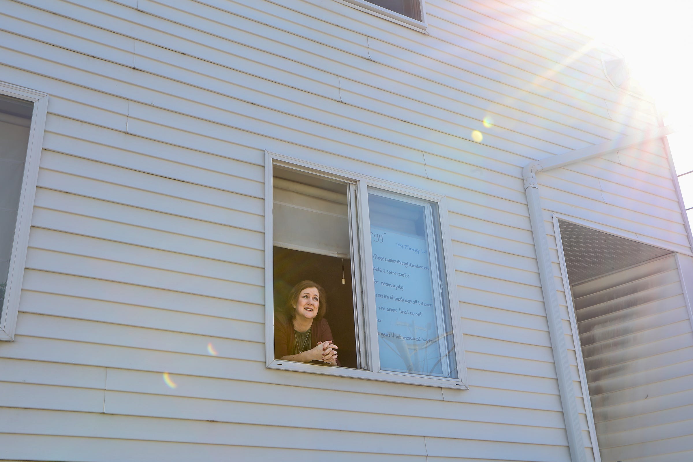 Every day, Mickey Lyons, 46, of Hamtramck writes a poem in the window of her home to celebrate National Poetry Month. “There have been other times when the world went through a tough period,” says Lyons. “We’re not alone even though we may be isolated.”