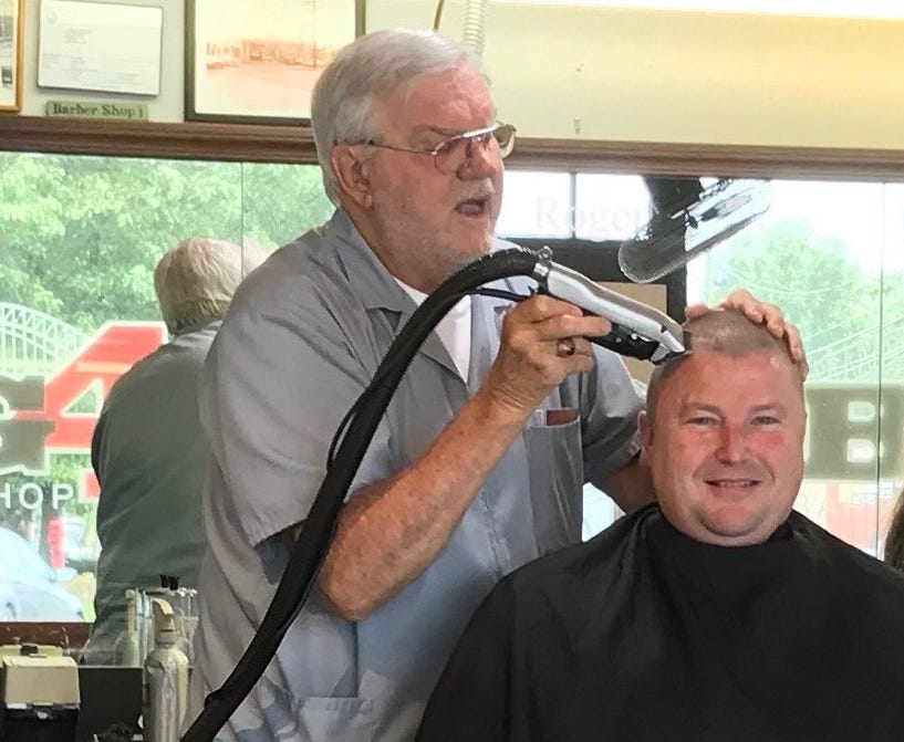 Roger Eckart cut the hair of Clark County Sheriff Jamey Noel in September 2018 at the Big 4 Barbershop in Jeffersonville, Indiana.
