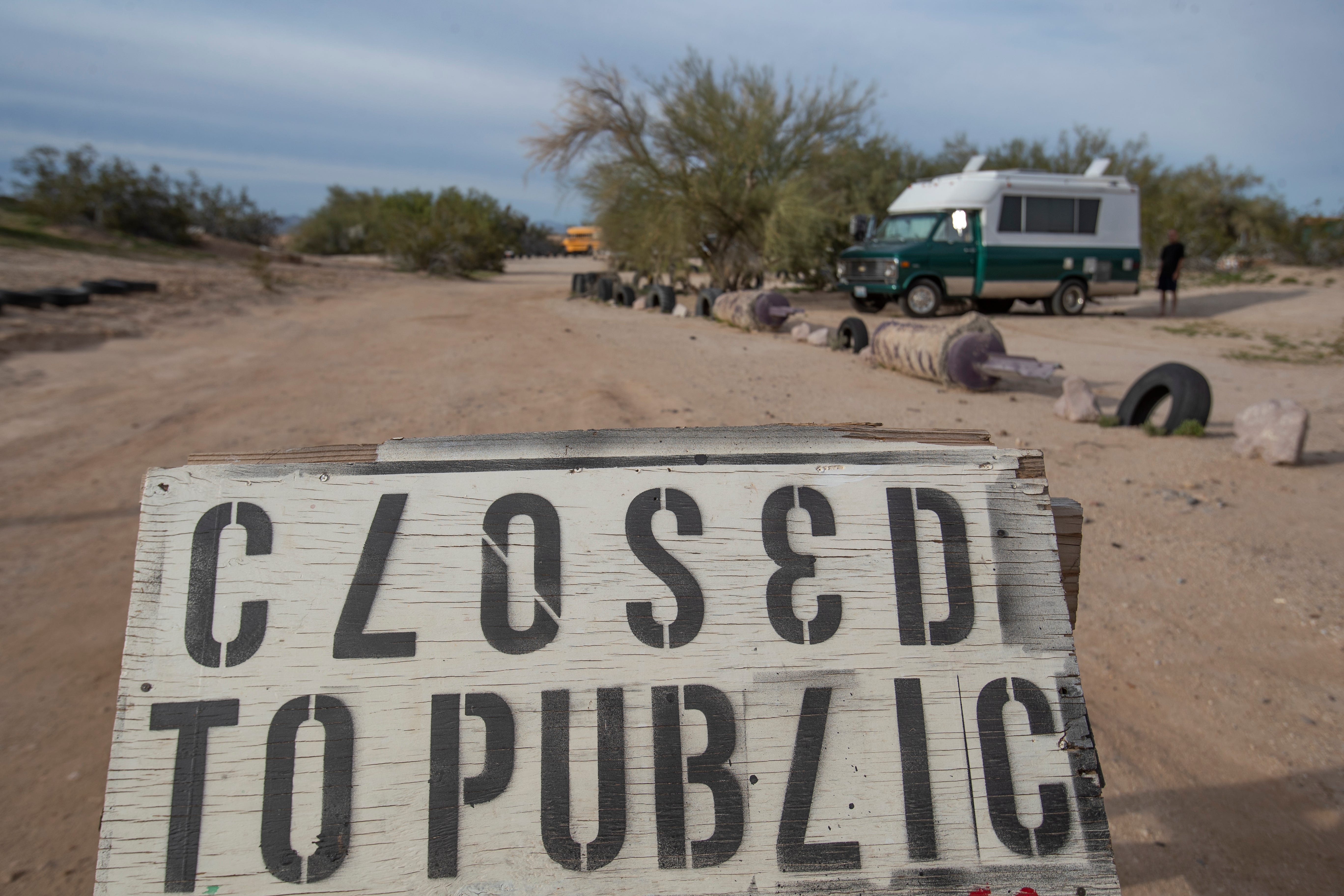 A sign is posted asking tourists and locals to refrain from entering the Slab City library as concerns about COVID-19 take hold throughout the community.