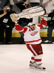 Henrik Zetterberg lifts the Stanley Cup after the Red Wings defeated the Penguins in 2008.