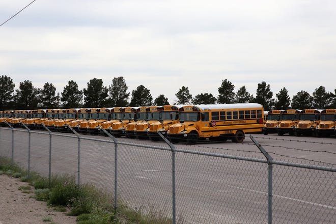 School buses parked at the Las Cruces headquarters of contractor STS of New Mexico on Monday, April 6, 2020.