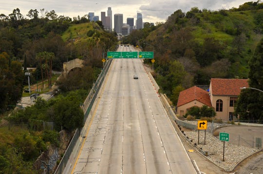 Extremely light traffic moves along the 110 Harbor Freeway on March 20 in Los Angeles.