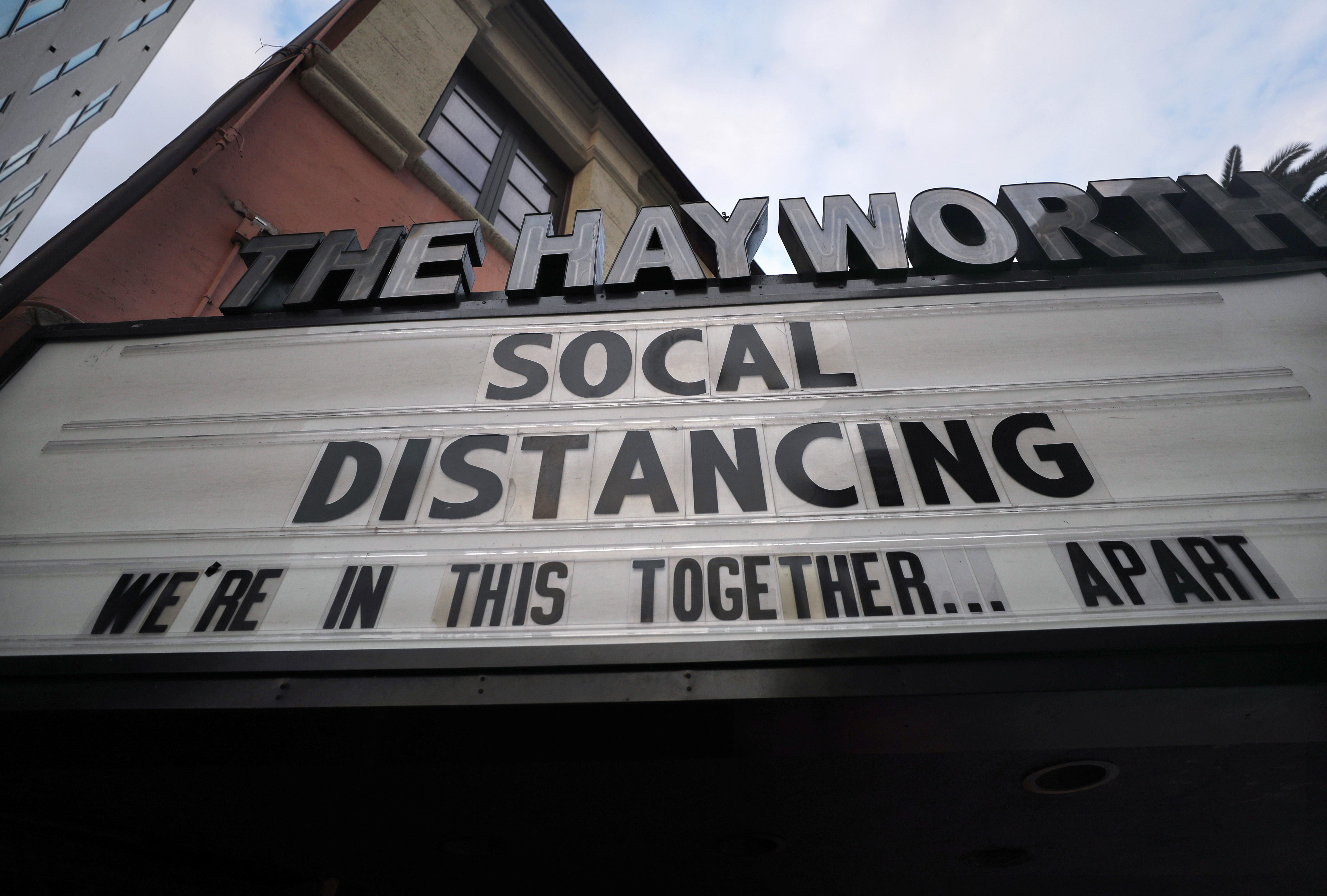 The shuttered Hayworth Theatre in Los Angeles displays the message 'Social Distancing We're In This Together...Apart' on the marquee, as the coronavirus pandemic continues, on March 23, 2020.