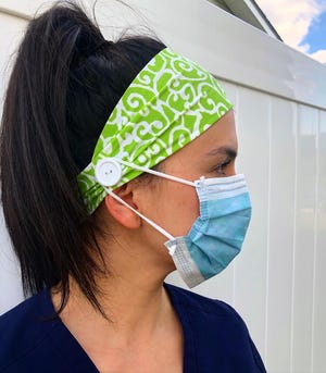 Sheila Newman, a nurse in Toms River, models a modified Ry-Bandz headband. The creator Ryann Jones started sewing buttons on the sides of the bands to protect healthcare workers' ears from being rubbed raw by medical masks as they care for COVID-19 coronavirus patients.