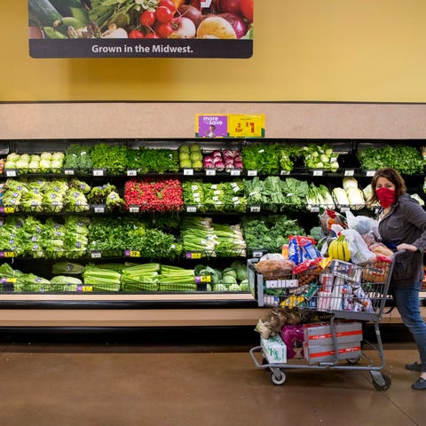 A shopper wears a mask while going through the pro