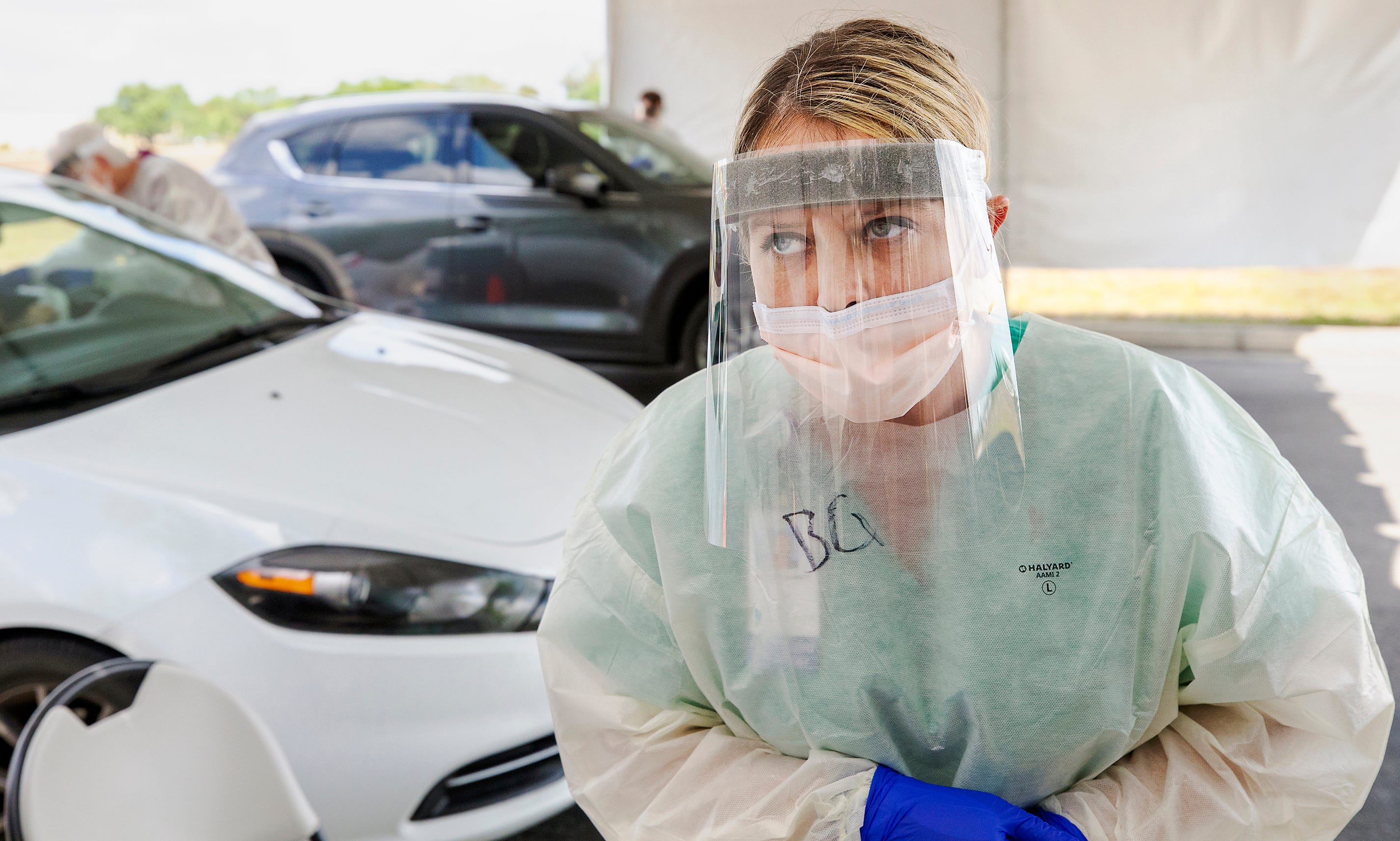 Advance provider Brittiany Garrett listens intently to a coworker’s question about a COVID-19 test sample at a mobile site in Fort Myers, Florida. The increasing number of people being tested requires nurses to pay extreme attention to detail when gathering and transporting test samples.