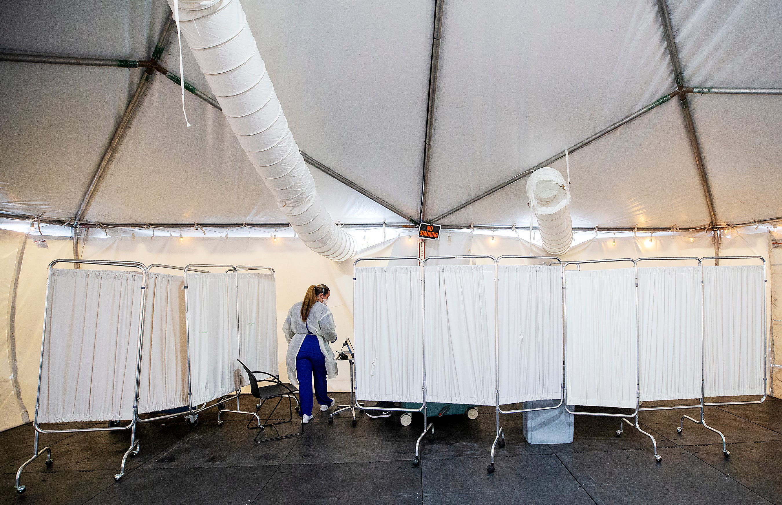 A triage tent to examine potential COVID-19 patients is set up outside Lee Memorial Hospital in Fort Myers, Florida.  The tents help prevent the virus from spreading into the emergency room and main hospital.